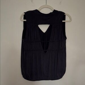 Free People black blouse with cutouts at the back and loose fit